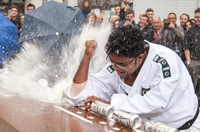 Muhammad-Rashid-crushing-drink-cans-with-his-elbow_